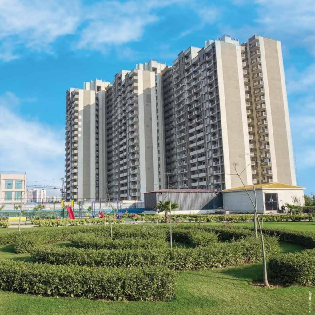 Coban Residences towers behind landscaped gardens, photographed in 2024.